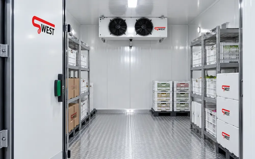 An aisle inside a working cold room: goods on racking, air circulating with no hot spots.